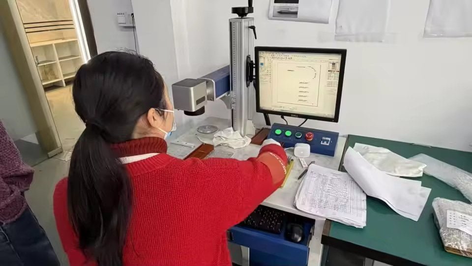 Production floor with large CNC machines and quality control inspection